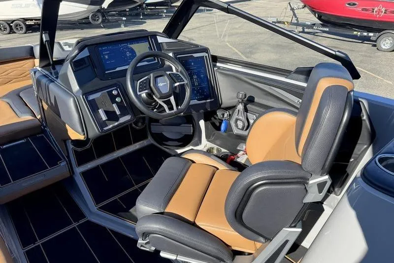 Slide: The Image of 2025 Supra SE boat cockpit with modern controls and tan leather seating. - 14