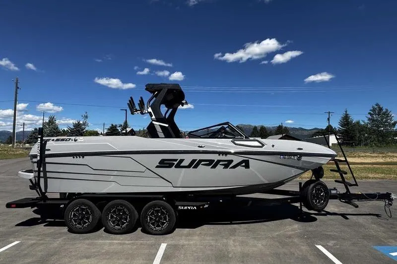 Slide: The Image of 2025 Supra SE boat on trailer under clear blue sky. - 5