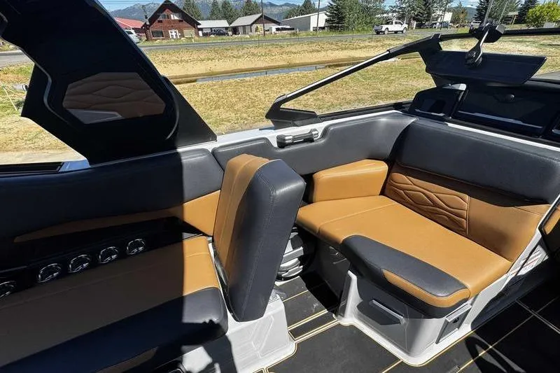 Slide: The Image of 2025 Supra SE boat interior with tan and black seating, showcasing modern design. - 9