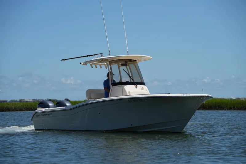 Slide: The Image of 2022 Grady-White Fisherman 257 boat cruising on calm water under clear blue sky. - 10