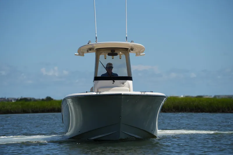 Slide: The Image of 2022 Grady-White Fisherman 257 boat cruising on calm water under clear blue sky. - 5