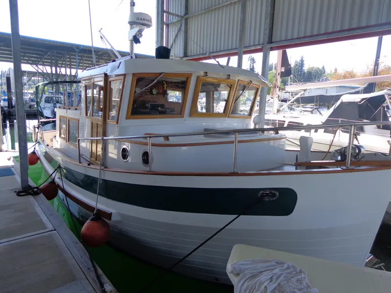The Image of 1984 Sundowner Tug Pilothouse docked in a marina. - 0