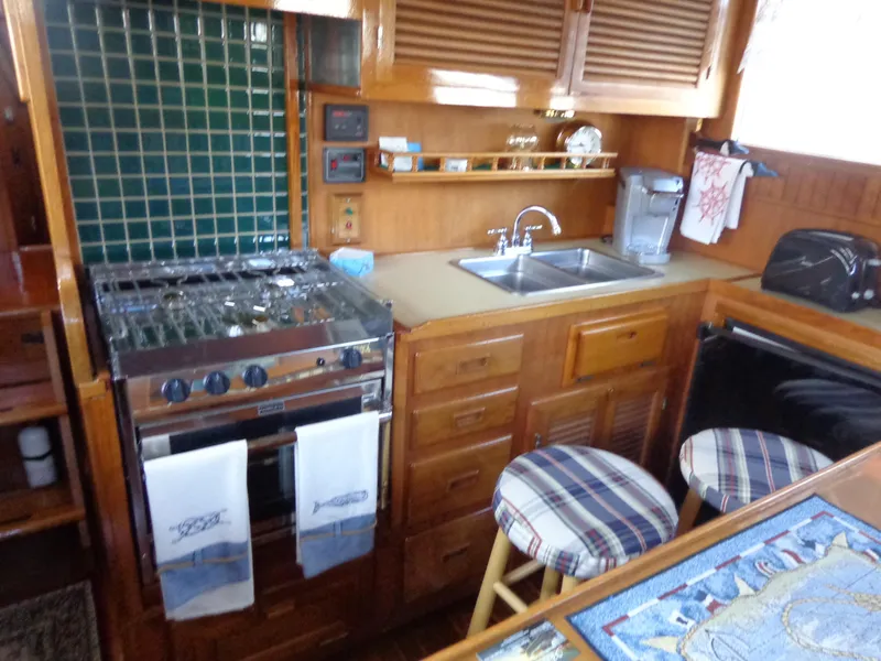 Slide: The Image of 1984 Sundowner Tug Pilothouse interior with plaid seating and nautical decor. - 14