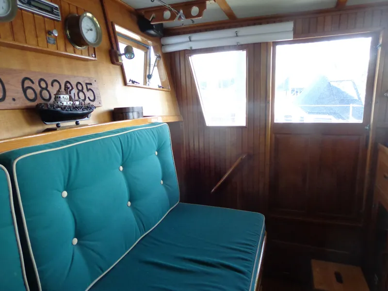 Slide: The Image of 1984 Sundowner Tug Pilothouse with Garmin navigation system and wooden steering wheel. - 22