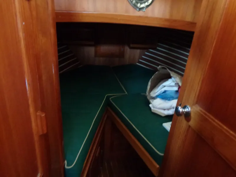 Slide: The Image of 1984 Sundowner Tug Pilothouse interior with teal cushioned seating and wooden paneling. - 23