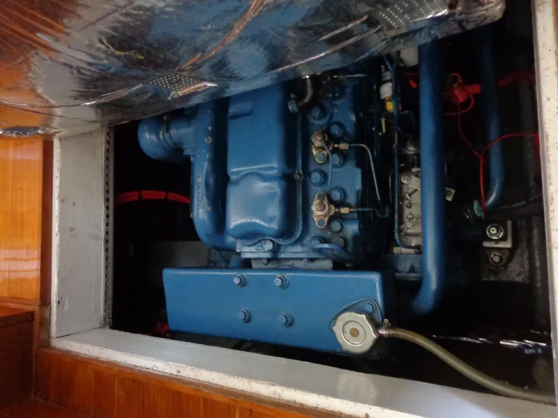 Slide: The Image of 1984 Sundowner Tug Pilothouse interior with wooden paneling and brass porthole. - 26