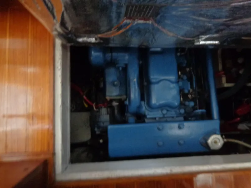Slide: The Image of 1984 Sundowner Tug Pilothouse engine compartment with blue machinery and wiring. - 28