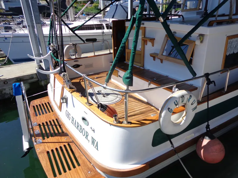 Slide: The Image of 1984 Sundowner Tug Pilothouse docked in a marina. - 3