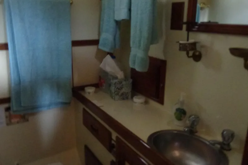 Slide: The Image of 1984 Sundowner Tug Pilothouse interior with wooden steering wheel and control panel. - 34