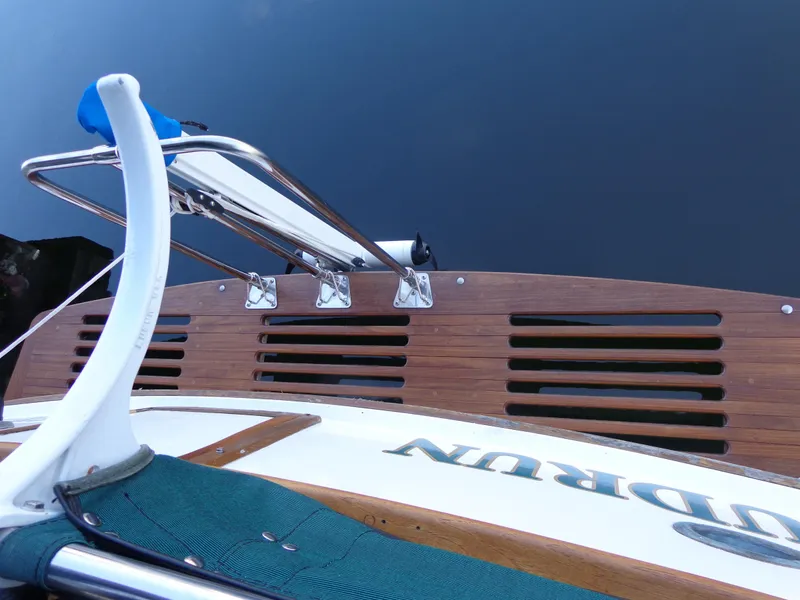 Slide: The Image of 1984 Sundowner Tug Pilothouse boat deck with wooden flooring and green canvas rail covers. - 38