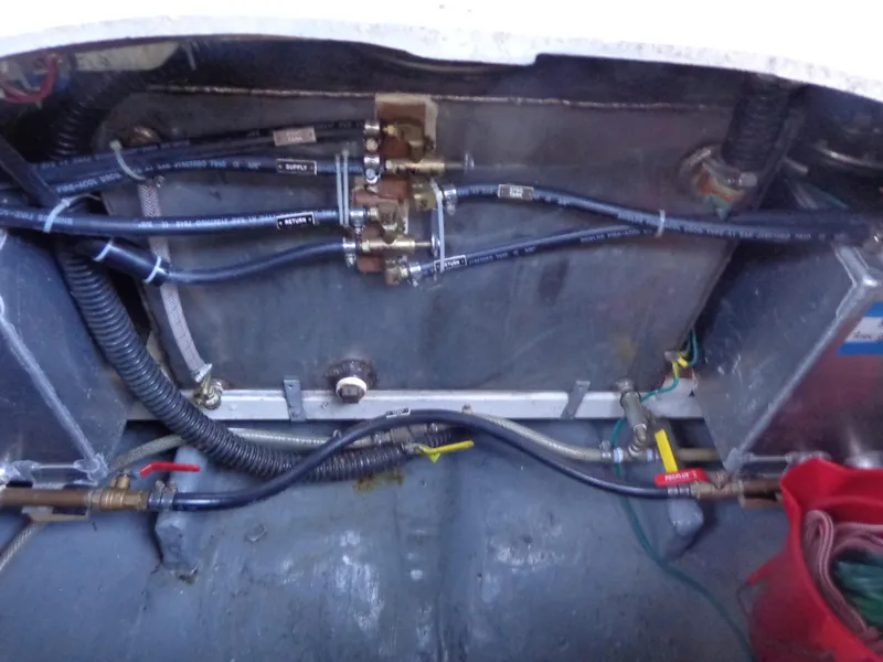 Slide: The Image of 1984 Sundowner Tug Pilothouse kitchen with stove, sink, and wooden cabinets. - 39