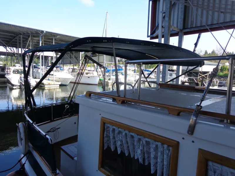 Slide: The Image of 1984 Sundowner Tug Pilothouse deck view under a covered dock. - 48