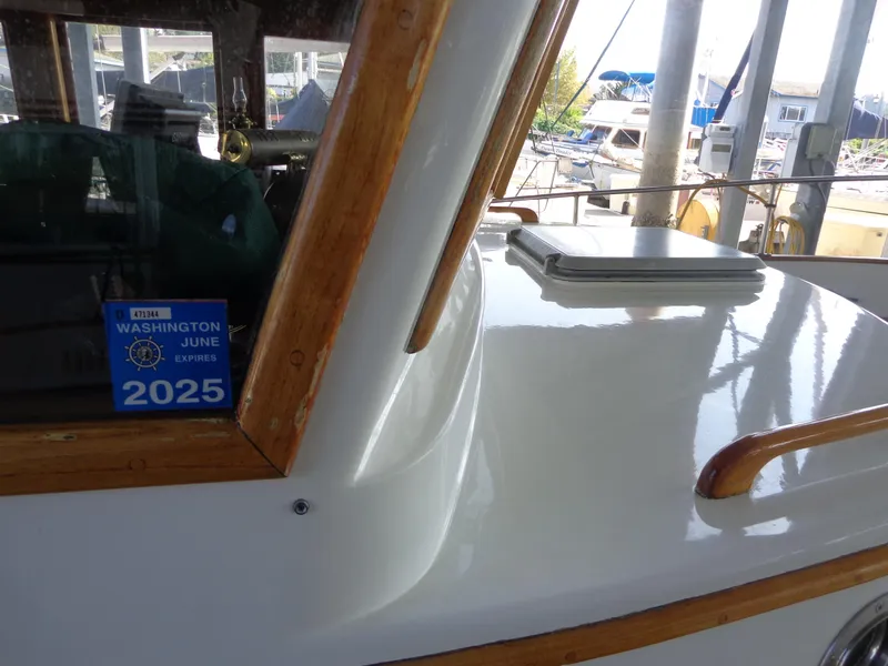 Slide: The Image of 1984 Sundowner Tug Pilothouse at marina with canopy and lace curtains. - 51