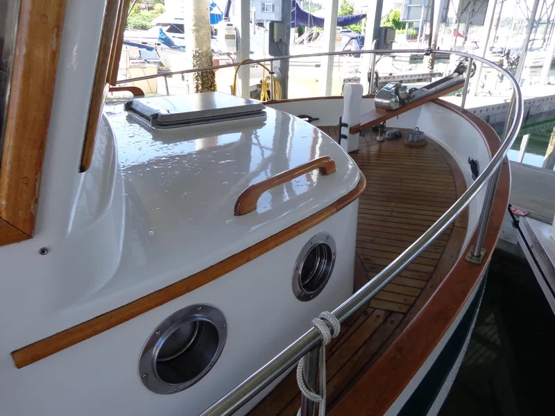 Slide: The Image of 1984 Sundowner Tug Pilothouse boat docked in a marina. - 6