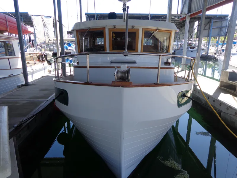 Slide: The Image of 1984 Sundowner Tug Pilothouse boat with wooden deck and stainless steel railings. - 7