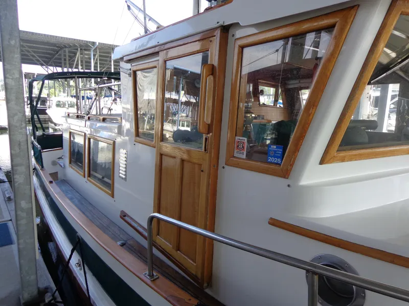 Slide: The Image of 1984 Sundowner Tug Pilothouse docked in a marina. - 8