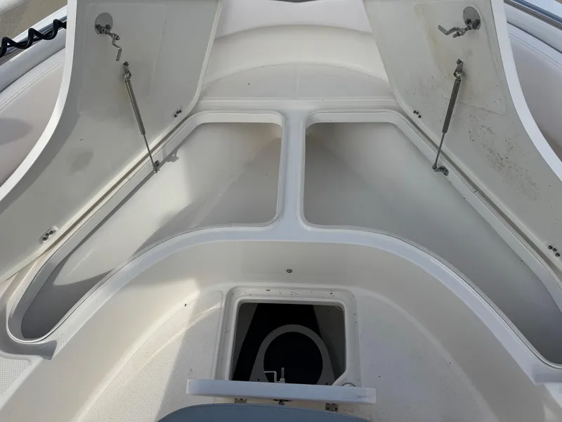Slide: The Image of Open storage compartments on a 2020 Robalo R222 Center Console boat. - 16