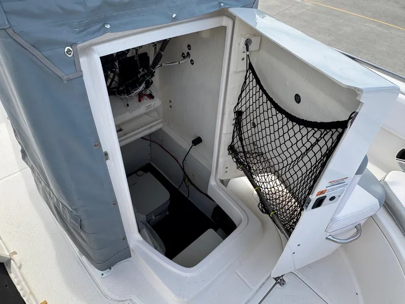 Slide: The Image of 2020 Robalo R222 Center Console boat storage compartment with netting and wiring. - 17