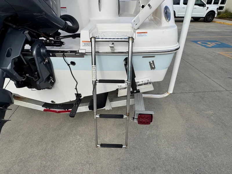 Slide: The Image of 2020 Robalo R222 Center Console boat with ladder and outboard motor on trailer. - 20