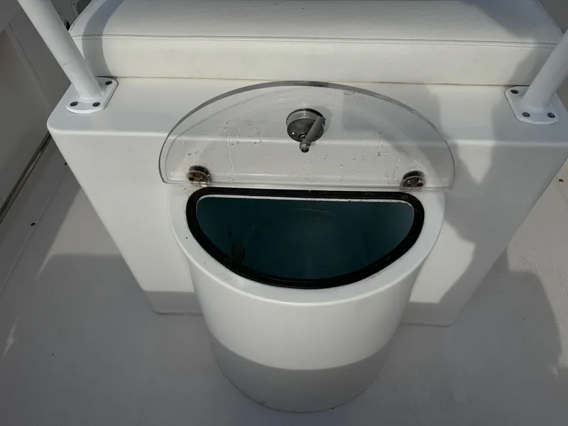 Slide: The Image of 2020 Robalo R222 Center Console livewell with cushioned seat. - 7