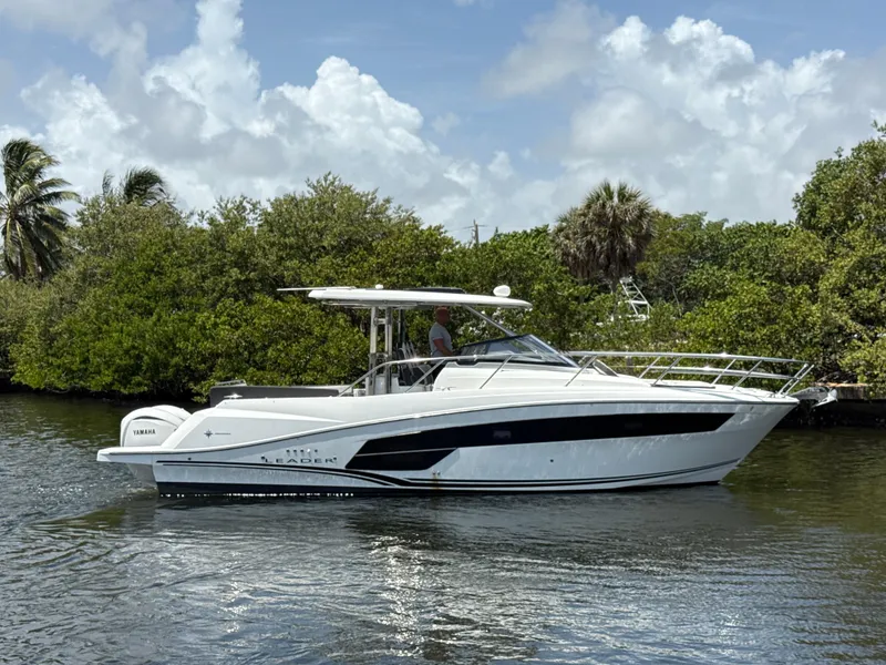 The Image of 2022 Jeanneau Leader 10.5 WA Series 2 boat cruising on a scenic waterway. - 0