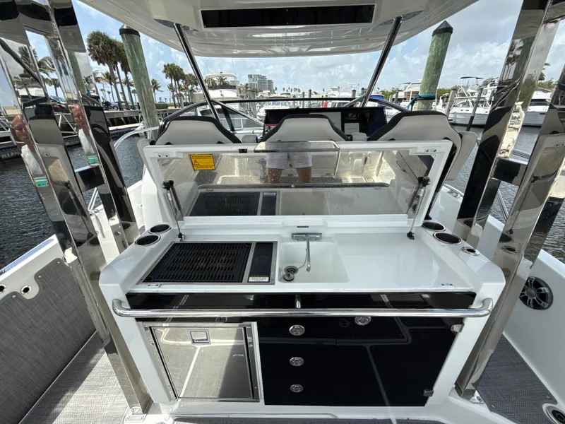 Slide: The Image of 2022 Jeanneau Leader 10.5 WA Series 2 boat interior with kitchenette and seating area. - 17