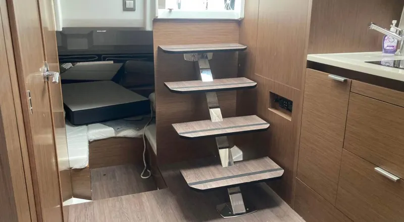 Slide: The Image of Interior of 2022 Jeanneau Leader 10.5 WA Series 2 with modern wooden stairs and cabin. - 28