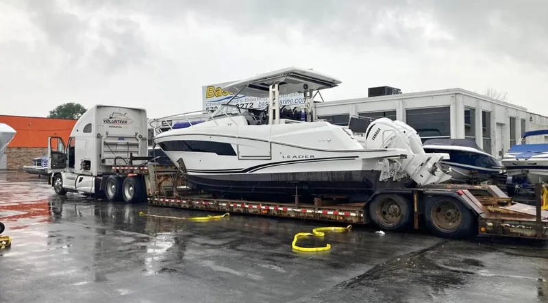 Slide: The Image of 2022 Jeanneau Leader 10.5 WA Series 2 boat on trailer in parking lot. - 30