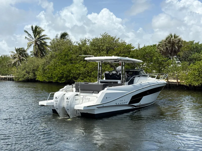 Slide: The Image of 2022 Jeanneau Leader 10.5 WA Series 2 boat on water, surrounded by lush greenery. - 4