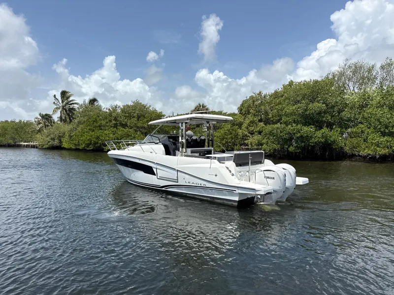 Slide: The Image of 2022 Jeanneau Leader 10.5 WA Series 2 boat cruising on a scenic waterway. - 6