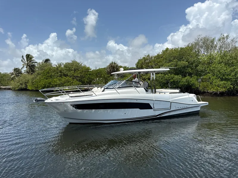 Slide: The Image of 2022 Jeanneau Leader 10.5 WA Series 2 boat cruising on a calm waterway. - 8