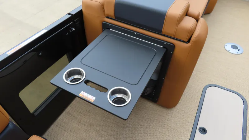 Slide: The Image of 2025 Princecraft Vogue 27 RL boat interior with fold-out table and cup holders. - 14