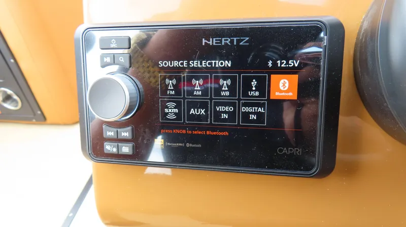 Slide: The Image of Hertz audio control panel on 2025 Princecraft Vogue 27 RL boat dashboard. - 21