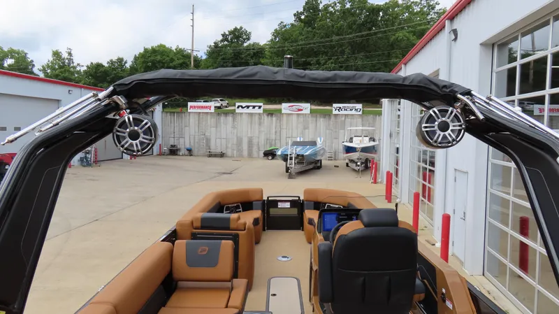 Slide: The Image of 2025 Princecraft Vogue 27 RL pontoon boat with luxurious seating and modern design at a marina. - 22