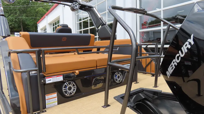 Slide: The Image of 2025 Princecraft Vogue 27 RL boat interior with tan seating and Mercury engine. - 27