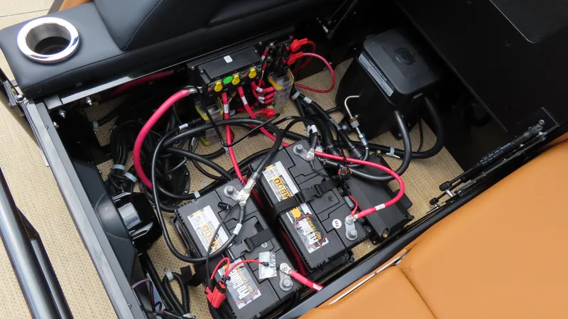 Slide: The Image of Battery compartment of 2025 Princecraft Vogue 27 RL boat with wiring and components. - 28