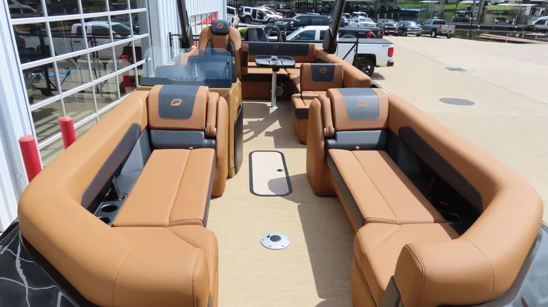 Slide: The Image of 2025 Princecraft Vogue 27 RL pontoon boat with luxurious tan seating and modern design. - 6