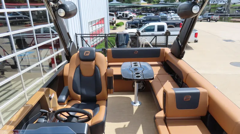Slide: The Image of 2025 Princecraft Vogue 27 RL boat interior with luxurious seating and modern steering console. - 7