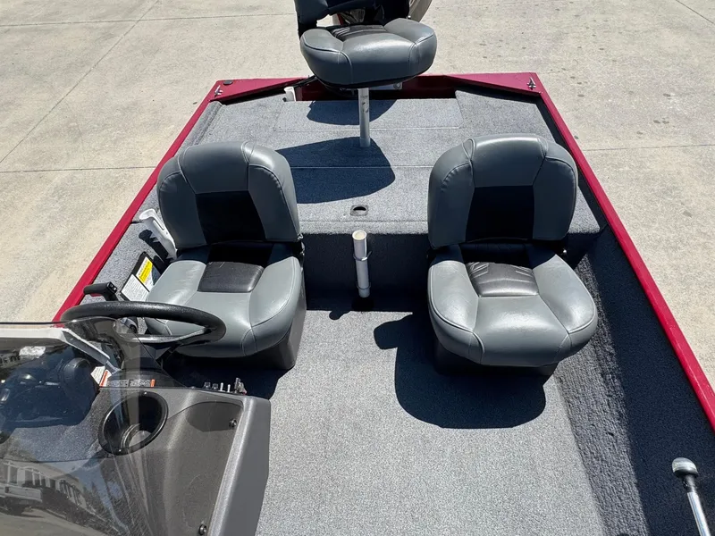 Slide: The Image of 2020 Bass Tracker Classic 16 boat interior with three gray seats and steering console. - 10