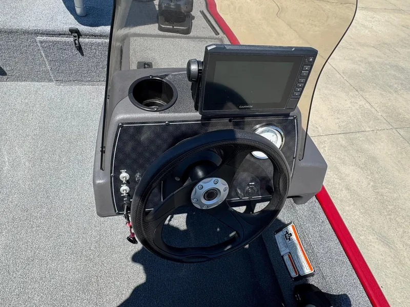 Slide: The Image of 2020 Bass Tracker Classic 16 dashboard with steering wheel and Garmin display. - 13
