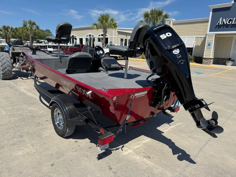 Slide: The Image of 2020 Bass Tracker Classic 16 boat with Mercury 50 engine, parked outdoors. - 2