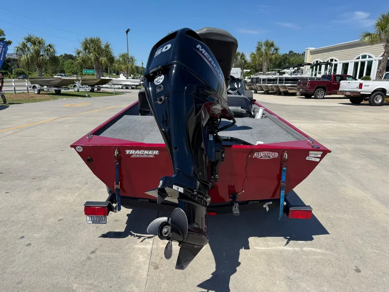 Slide: The Image of 2020 Bass Tracker Classic 16 boat with Mercury outboard motor, parked outdoors. - 3