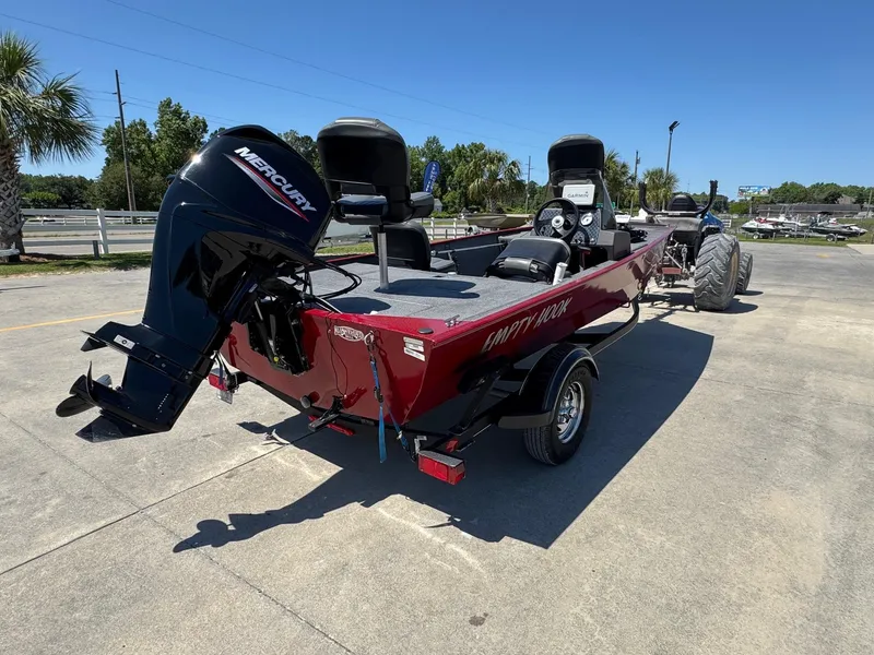Slide: The Image of 2020 Bass Tracker Classic 16 boat with Mercury engine on a trailer, parked outdoors. - 5