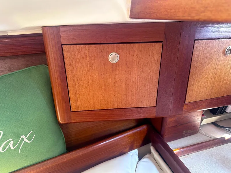 Slide: The Image of Wooden cabinet interior of 1997 Hunter 310 sailboat with green cushion. - 11