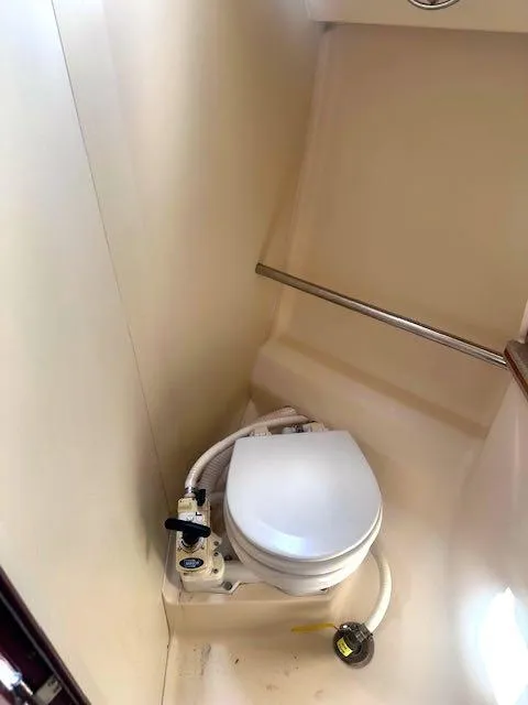 Slide: The Image of Compact marine toilet in a 1997 Hunter 310 sailboat bathroom. - 13