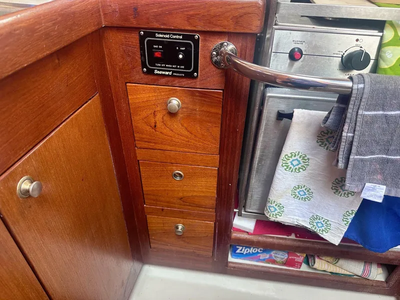 Slide: The Image of Wooden interior of a 1997 Hunter 310 yacht with solenoid control and kitchen storage. - 15