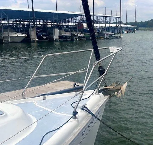 Slide: The Image of 1997 Hunter 310 sailboat docked at marina with other boats in background. - 5