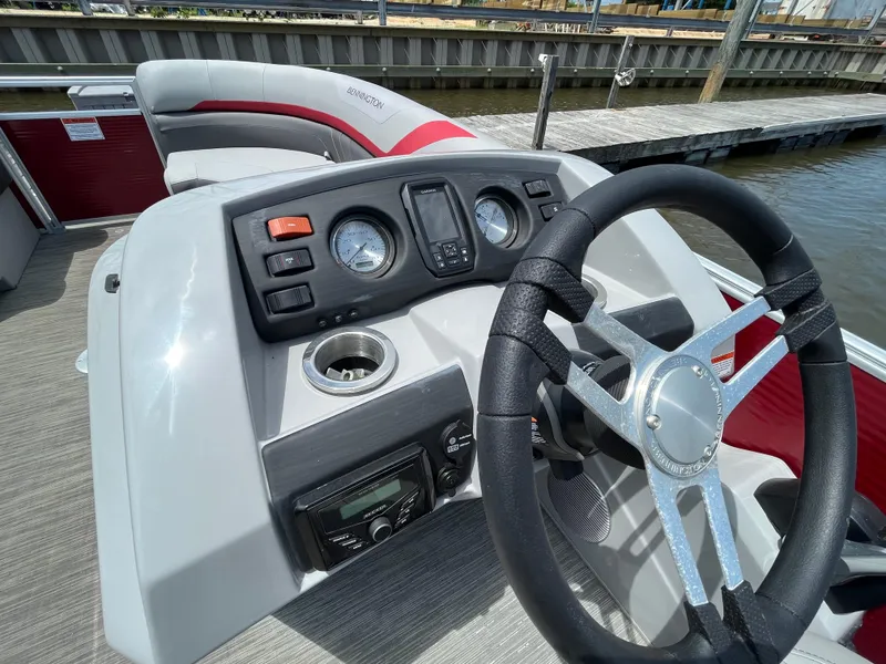 Slide: The Image of 2022 Bennington 22SSRCX boat dashboard with steering wheel and control panel. - 12