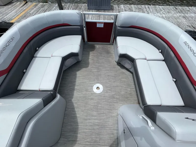 Slide: The Image of 2022 Bennington 22SSRCX pontoon boat interior with gray and red seating. - 15