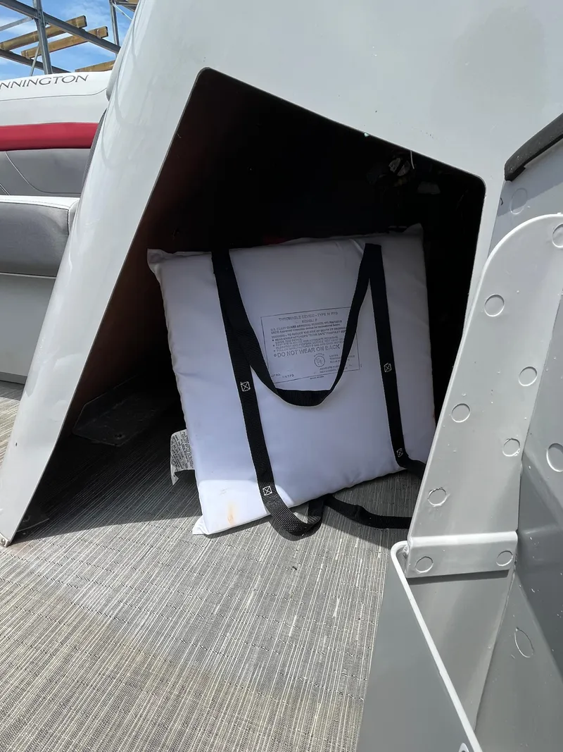 Slide: The Image of 2022 Bennington 22SSRCX boat storage area with a white cushion inside. - 17